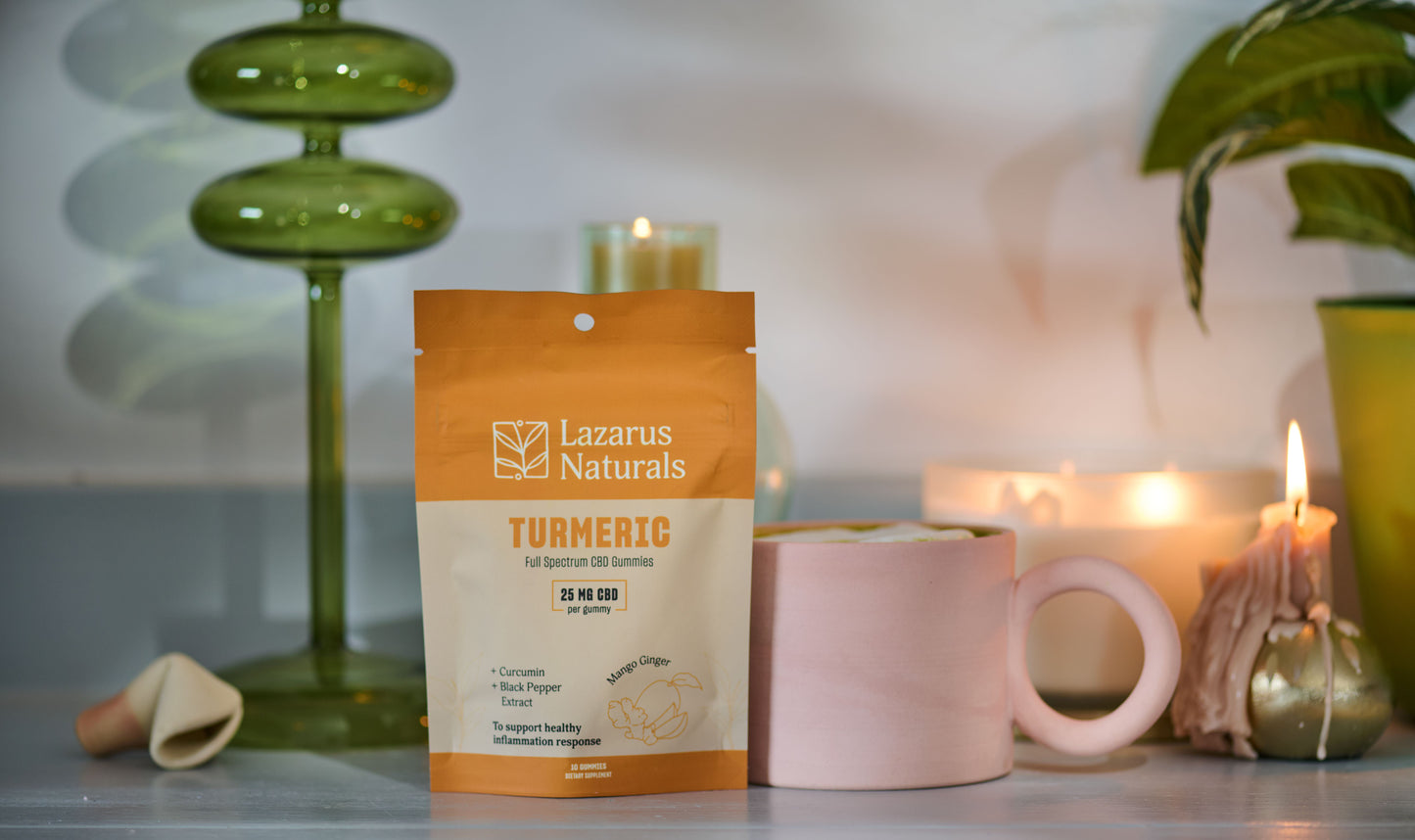 Lazarus Naturals Turmeric Gummies 10 count bag next to a mug of coffee & a candle